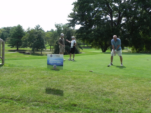 Speaker of the Delaware House of Representatives Pete Schwartzkopf tees off at the tournament with teammates RL Hughes (left) and Laura O??Sullivan waiting
